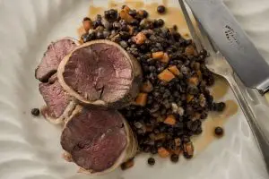 Roasted loin of venison with braised lentils